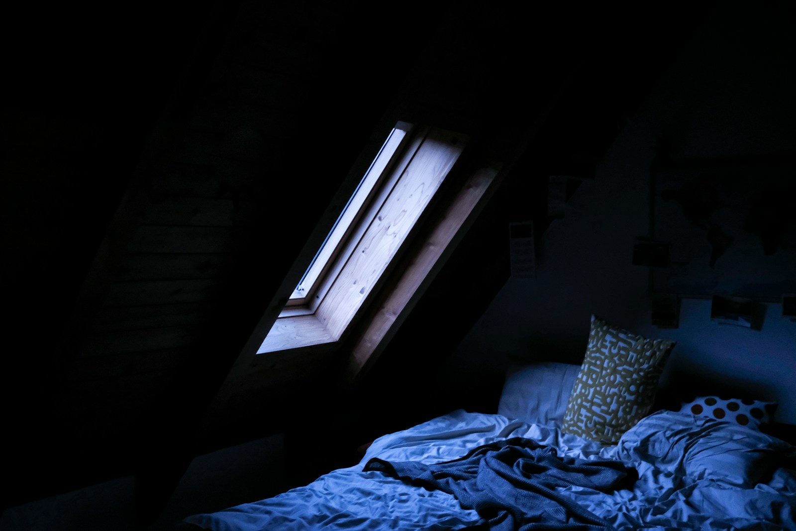 An unmade bed in soft daylight near a window — the quiet weight of a morning when sleep didn't come easily